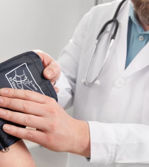 Doctor with blood pressure monitor